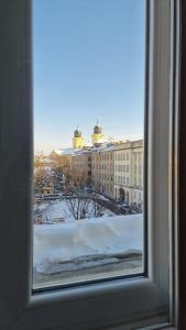 a view of a snowy city from a window at Boudoir-Art Studio Apartment in Debrecen