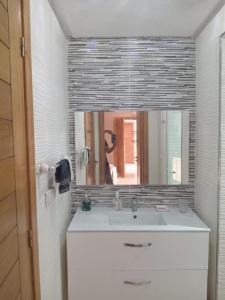 a bathroom with a sink and a mirror at Appartement pieds dans l'eau Aghroud in Tamri +13 photos