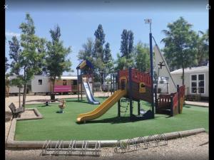 a playground with a slide in a park at Bien dans le sud in Fréjus