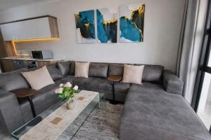 a living room with a couch and a table at Spectacular Lagoon Facing Apartment - The Blyde in Pretoria