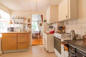 a kitchen with white cabinets and a stove at HAL820-Unnaryd-Soedra-vaegen-29-a in Unnaryd