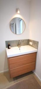 a bathroom with a sink and a mirror at La Maison Trente in Chooz +33 photos
