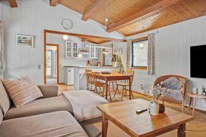 a living room with a couch and a table at 3000-Stege-Stejlepladsen-13 in Stege