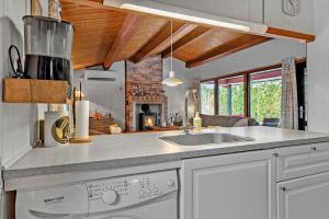 a kitchen with a sink and a stove at 3000-Stege-Stejlepladsen-13 in Stege