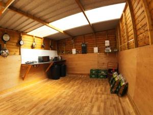 a large room with a wooden floor and a table at Clover in Welland