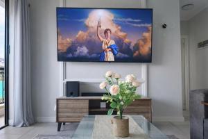 a living room with a flat screen tv on a wall at Spectacular Lagoon Facing Apartment - The Blyde in Pretoria +42 photos