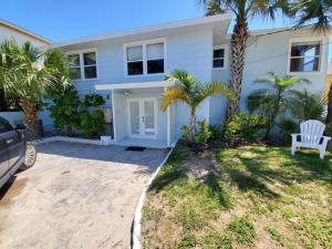 a white house with palm trees in front of it at The Dunes in St. Augustine