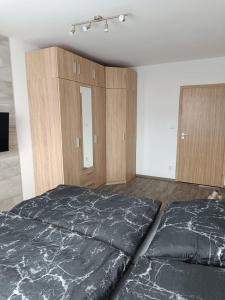 a bedroom with two beds and wooden cabinets at Apartmán Velký Luh in Velký Luh