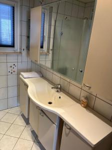 a white bathroom with a sink and a mirror at Freundliche Monteurwohnung in Bad Oldesloe