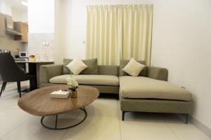 a living room with a couch and a coffee table at The Empire Tower in Manama