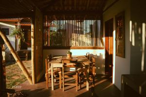 a dining room with a wooden table and chairs at Chalés VerdeSer in Sêrro +36 photos