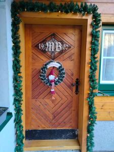 a door to a house with a christmas wreath at Ferienhaus Bauer Wohnung 2 in Trattenbach
