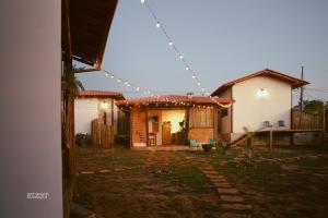 a house with a string of lights on it at Chalés VerdeSer in Sêrro
