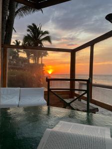 a view of a sunset from a resort with a swimming pool at Refugio Alana Máncora in Máncora