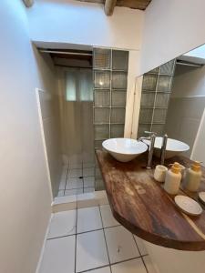 a bathroom with two sinks and a mirror at Refugio Alana Máncora in Máncora +26 photos
