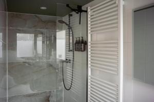 a bathroom with a shower with a glass wall at City Attic Haarlem in Haarlem