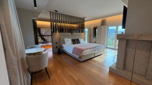 a large bedroom with a bed and a fireplace at Quinta Solar das Fontes in Várzea +145 photos