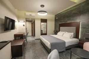 a hotel room with a bed and a television at Tabar Hotel in Nazareth