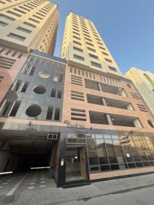 a building with two tall buildings in the background at The Empire Tower in Manama