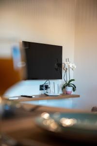 a computer monitor sitting on top of a desk at Mystrali 1BD Modern Apt with Private Garden in Galatás