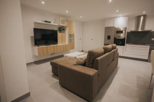 a large living room with a couch and a tv at Casas del Pedregal Apartamento 1 in A Estrada +21 photos