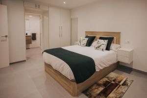 a bedroom with a large bed with a black blanket at Casas del Pedregal Apartamento 1 in A Estrada