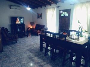 a living room with a table and chairs and a woman at La finca in San Rafael