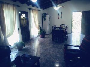 a living room with a table and a dining room at La finca in San Rafael