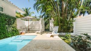 a backyard with a swimming pool and a house at Couples Tower Isle in Ocho Rios