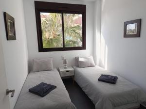 two twin beds in a room with a window at Royal Park Green Spa in Orihuela Costa +76 photos