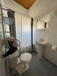 a bathroom with a toilet and a sink at Hostal Mar De Bahía in Bahia Inglesa +35 photos