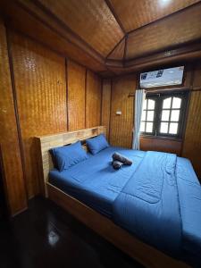a bedroom with a bed with a stuffed animal on it at Ploy Chumpoo Kantiang in Ko Lanta