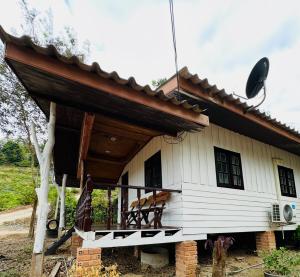 a small white house with a porch at Ploy Chumpoo Kantiang in Ko Lanta