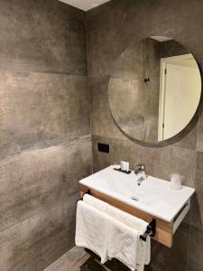 a bathroom with a sink and a mirror at Hotel & Appartementen Royal in Sas van Gent