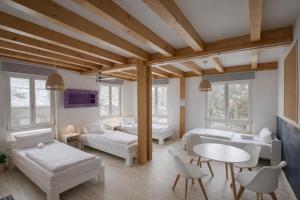 a living room with white furniture and windows at Hamburg Sleep Club in Hamburg
