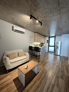 a living room with a couch and a table at Canela Loft Rosario in Rosario +10 photos