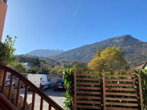 a wooden fence with a view of a mountain at Studio avec toutes les commodités autour in Faverges