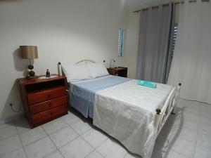 a bedroom with a bed and a wooden dresser and a bed sidx sidx sidx at ROMANA guest house in Tarrafal da Vila de Ribeira Grande +7 photos