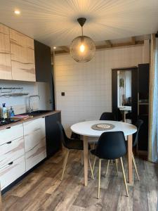 a kitchen and dining room with a table and chairs at Les cottages du Tremble in Ruffec