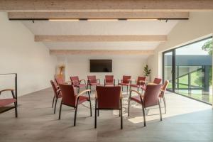 a conference room with a table and chairs at Oase 41 - 5 STAR location with Indoor swimming pool & unique landscape view in Sint-Laureins