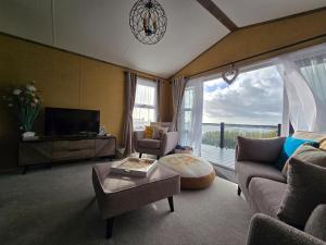 a living room with a couch and a tv at 1 Sunset View in Millom
