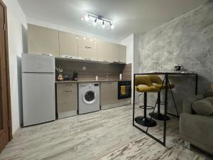 a kitchen with a refrigerator and a washing machine in it at Le Bijou МОЛ Плаза in Plovdiv +10 photos