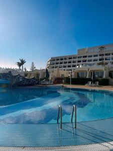 a large swimming pool in front of a hotel at Borg El Arab Beach Resort in Dawwār ‘Abd al Qādir Qāsim