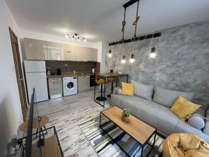 a living room with a couch and a kitchen at Le Bijou МОЛ Плаза in Plovdiv
