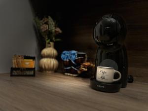 a coffee maker and a cup on a table at Le Bijou МОЛ Плаза in Plovdiv