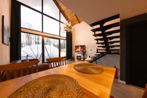 a room with a wooden table with a large window at Rubis Villa Bungalov in Elmalık
