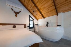 a bedroom with a bed and a bath tub at Rubis Villa Bungalov in Elmalık +28 photos