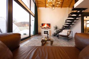 a living room with a couch and a fireplace at Rubis Villa Bungalov in Elmalık
