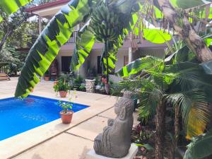 a villa with a pool and a pineapple tree at Tekana Boutique Hotel Jungle Retreat in Tamarindo +24 photos