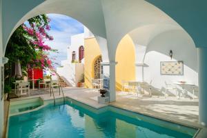 an external view of a swimming pool in a house at Aigialos Luxury Traditional Settlement in Fira